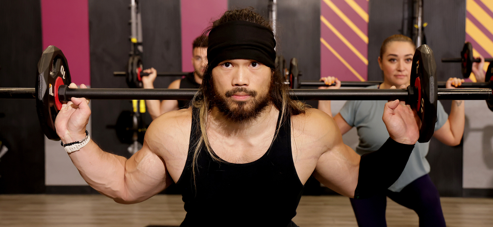 people in a workout class using barbells